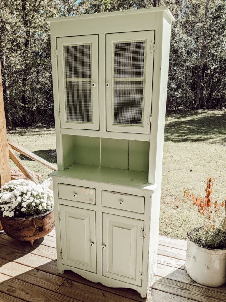 green cabinet with open wire doors on top