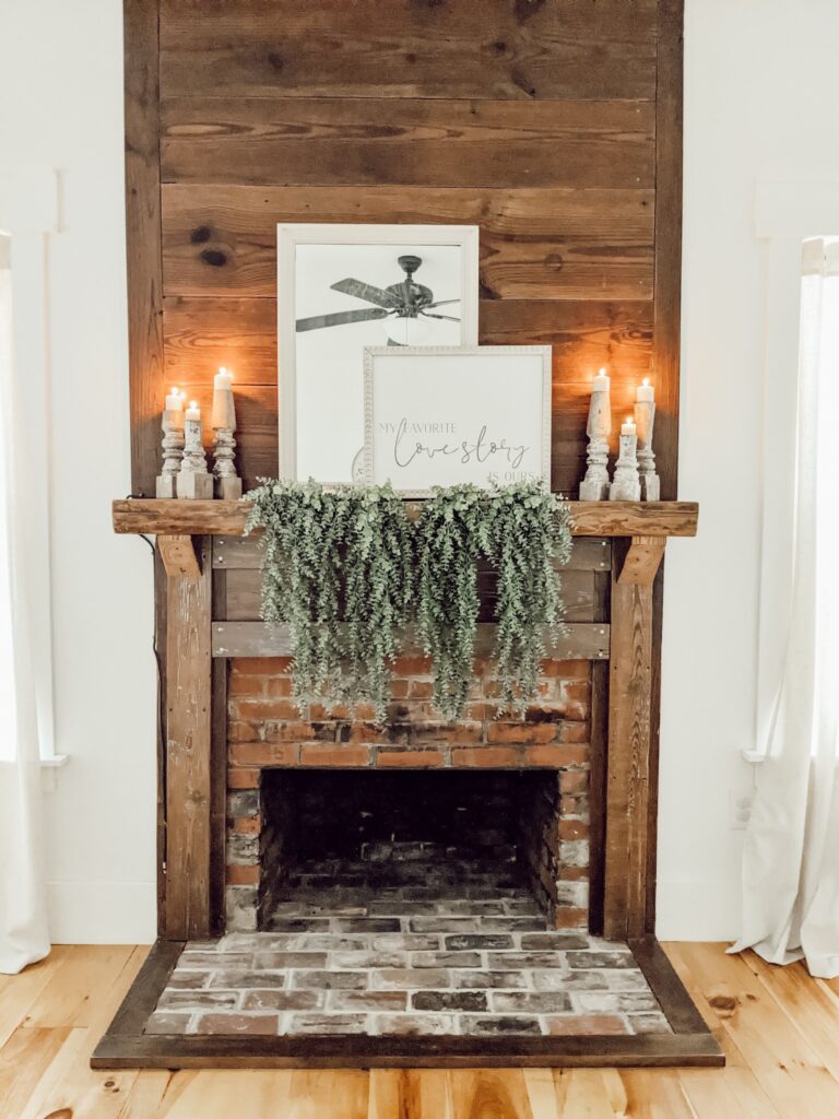 reclaimed wood fireplace mantle and chippy white paint candle holders